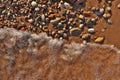 Directly Above Flatlay of Gentle Waves Lapping Sand and Pebble Beach with Pristine Clear Cool Water Royalty Free Stock Photo