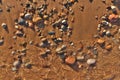 Directly Above Flatlay of Gentle Waves Lapping Sand and Pebble Beach with Pristine Clear Cool Water