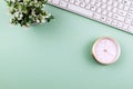 Flat Lay office desk with alarm clock and potted plant