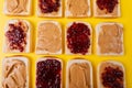 Directly above shot of bread slices with preserves and peanut butter arranged alternatively