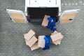 Delivery Men Unloading Cardboard Boxes From Truck On Street Royalty Free Stock Photo