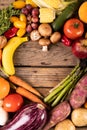 Directly above shot of various vegetables and fruits with empty heart shape made on wooden table Royalty Free Stock Photo