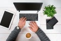 Directly above view of human hands typing on laptop. Royalty Free Stock Photo