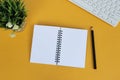 Directly above view of office desk with yellow background. Copy space. Flat lay. Royalty Free Stock Photo