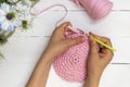 Directly above view of woman hands holding crochet hook and crocheting with ribbon yarn Royalty Free Stock Photo