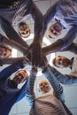 Directly below portrait of business colleagues stacking hands at office