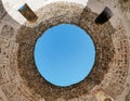 Open circle with view of blue sky on roof of ancient tower in Diocletian's palace in Split, Croatia.