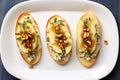 directly overhead shot of three apple gorgonzola bruschettas on a white plate