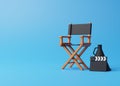 Director chair, clapperboard and megaphone on blue background Royalty Free Stock Photo