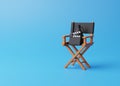 Director chair, clapperboard and megaphone on blue background Royalty Free Stock Photo