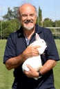 The director Luciano Capponi with a rabbit in her arms