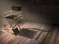 Director`s chair with clapper board and megaphone in dark room scene with spotlight light Royalty Free Stock Photo