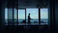 Director silhouette walking sea panoramic window. Leader boss waiting in hotel