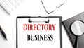 DIRECTORY BUSINESS text written on paper clipboard with office tools Royalty Free Stock Photo