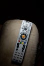 DirecTV remote on arm of recliner with plenty of copyspace