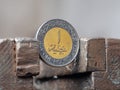 Dirham coin clamped in a metal vise. Currency and United Arab Emirates economy under the onslaught, the concept of financial