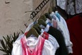 Dirndl dresses of various colors hanging a rack