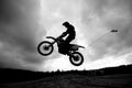 Dirt bike jumping sand dunes - Sihlouette Royalty Free Stock Photo