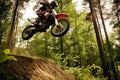 dirt biker soaring over a small hill in a forest