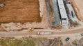 a dirt field near several yellow buses and trucks next to each other Royalty Free Stock Photo