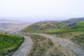 dirt muddy road wet Puddle countryside autumn fall green grass steppe after rain Tire tracks beautiful landscape Moldova Royalty Free Stock Photo