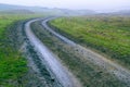 dirt muddy road wet Puddle countryside autumn fall green grass steppe after rain Tire tracks beautiful landscape Moldova Royalty Free Stock Photo