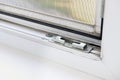 Dirt in open window with mosquito net need to clean.Window mechanism close-up.losing mechanism of plastic windows.Secure anti-thef Royalty Free Stock Photo