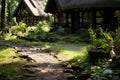 a dirt path in front of a thatched roofed house