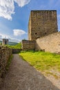 Dirt path leading to a stone wall in the Esch-sur-Sure castle ruins Royalty Free Stock Photo