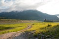 Dirt road along Snake River and Central Rocky Mountains under cumulus cloud sky in Alpine Wyoming Royalty Free Stock Photo