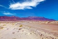 Dirt road in arid barren dry landscape, red mountains, clear blue sky - Road trip to Punta de Jandia, Fuerteventura Royalty Free Stock Photo