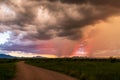 Dirt road in Arizona countryside with ominous dark monsoon clouds Royalty Free Stock Photo