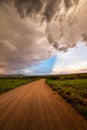 Dirt road in Arizona countryside with ominous dark monsoon clouds Royalty Free Stock Photo