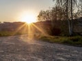 A dirt road on the border of a lake in Switzerland in Spring at sunset