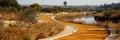 Dirt road curves with water in background