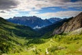 Meadows and jagged peaks of Carnic Alps and Dolomiti Pesarine Royalty Free Stock Photo