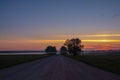 Dirt road deep in the forest. A sunset