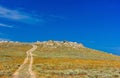 Dirt road in the desert clear day Royalty Free Stock Photo