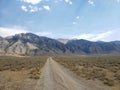 Dirt road into the desert mountain Royalty Free Stock Photo