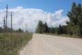 Dirt road empty with a thundercloud in the sky over a field landscape of nature in Siberia Royalty Free Stock Photo