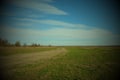 Dirt Road In The Fields On A Spring Day. Country Landscape. Beautiful Cloudy Sky Over The Field. Vignette