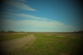 Dirt Road In The Fields On A Spring Day. Country Landscape. Beautiful Cloudy Sky Over The Field. Vignette