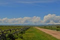 Dirt Road Headed to the Mountains and the Montana Big Sky with clouds Royalty Free Stock Photo