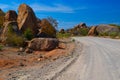 Dirt road through large stones