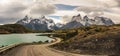 Dirt road leading around the lake to stunning Cuernos del Paine in Patagonia. Torres del Paine National Park, Patagonia, Chile the Royalty Free Stock Photo