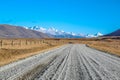 Dirt road leading to mountains in Ashburton Lakes District, South Island, New Zealand Royalty Free Stock Photo