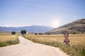 dirt road leading to the mountains in the country, there are fields on the side. and trafic signs Royalty Free Stock Photo
