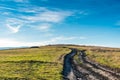 Dirt road leading to the top of the hiil Royalty Free Stock Photo