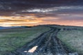 Dirt road leading to the top of the hill at sunset Royalty Free Stock Photo
