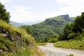 Dirt road leading up into rough mountains